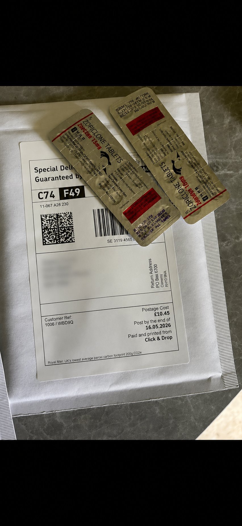 Postal package containing two vintage cigarette packages with red bands and Chinese text, accompanied by a Royal Mail shipping label